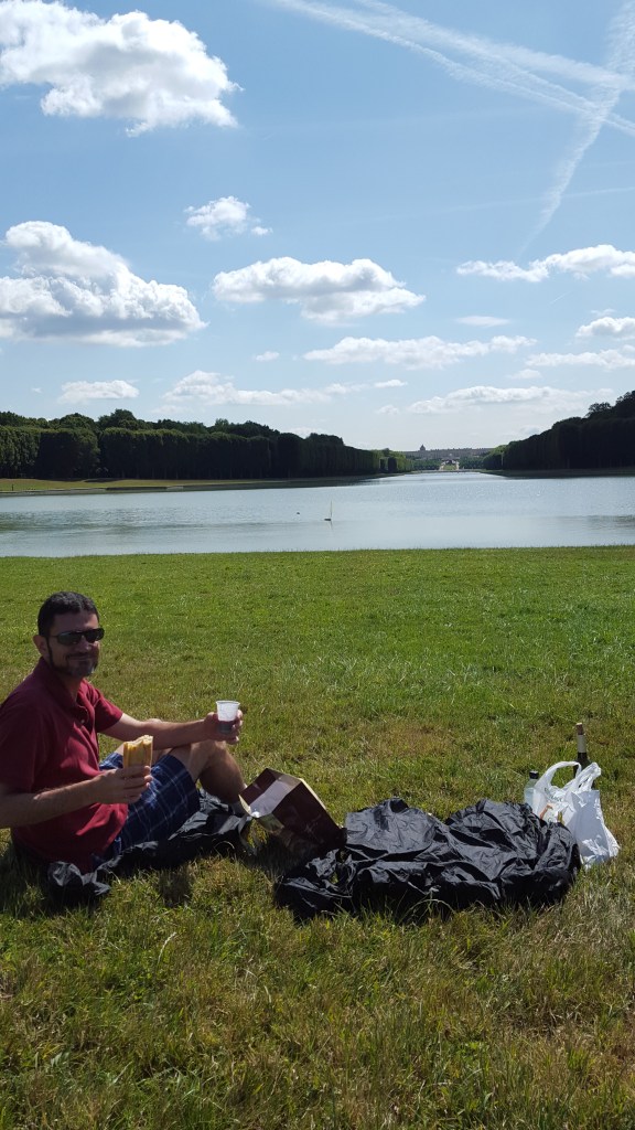 Picnic lunch on the grand canal at Versailles at the end of the mile long canal behind the palace. The canal is cross shaped with treelined paths surrounding it, perfect for biking.